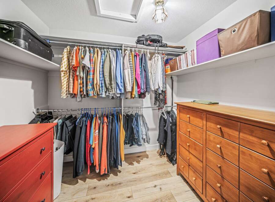 Step into this well-organized walk-in closet, offering ample storage space for your wardrobe.