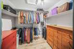 Step into this well-organized walk-in closet, offering ample storage space for your wardrobe.