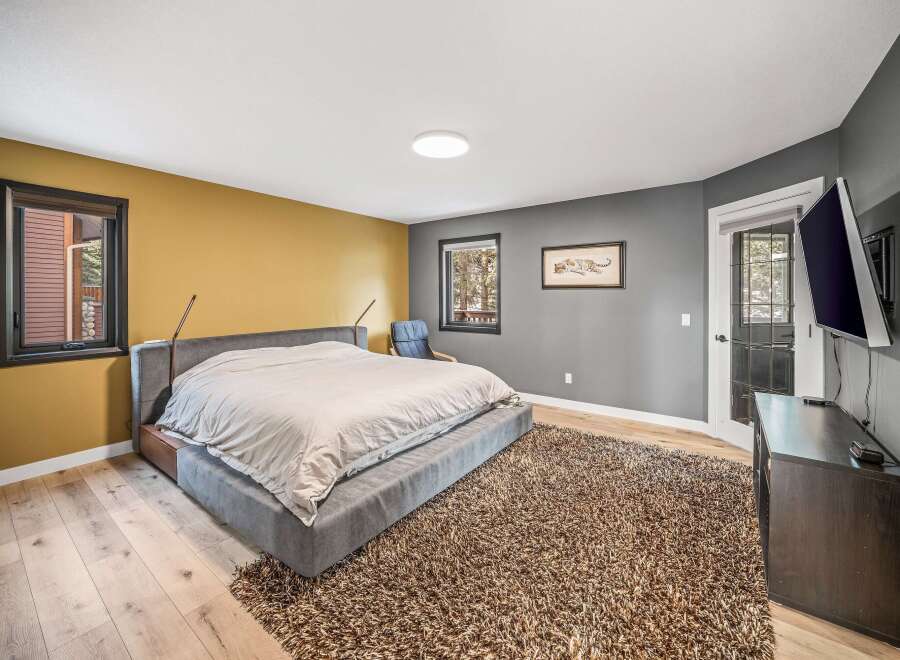 Step into a luxurious bedroom retreat, featuring a plush, oversized bed and a cozy, textured rug.