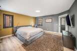 Step into a luxurious bedroom retreat, featuring a plush, oversized bed and a cozy, textured rug.