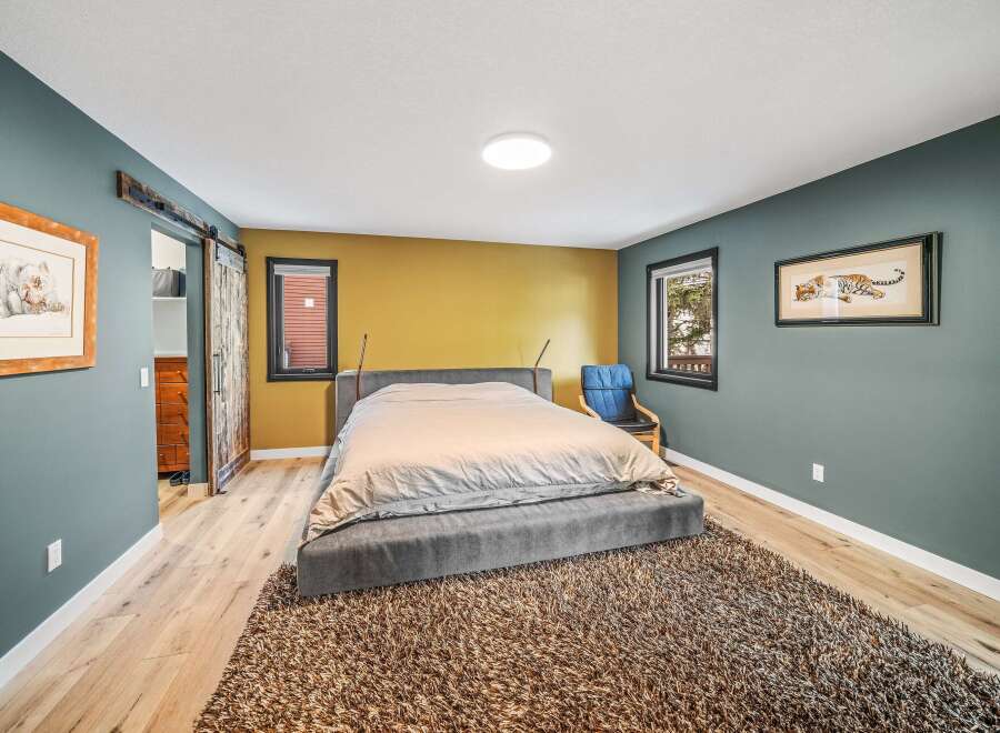 This stunning bedroom boasts a modern design with a touch of rustic charm.