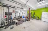 This spacious garage has been transformed into a functional home gym, perfect for fitness enthusiasts.
