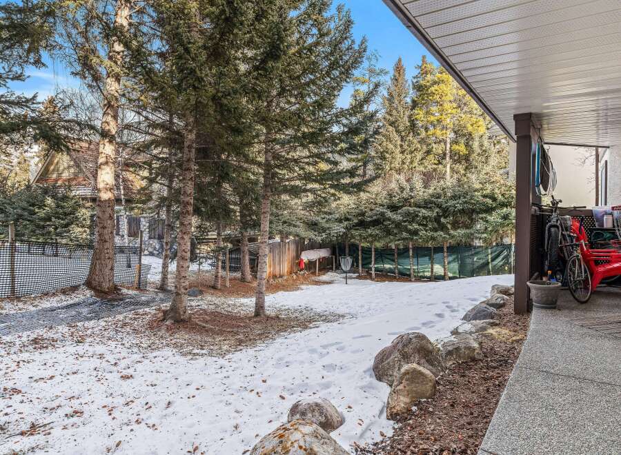 Discover the charm of this property, featuring a serene backyard with a touch of winter's beauty.