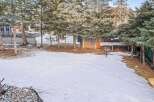 Enjoy the serene beauty of this property, featuring a spacious backyard blanketed in fresh snow.