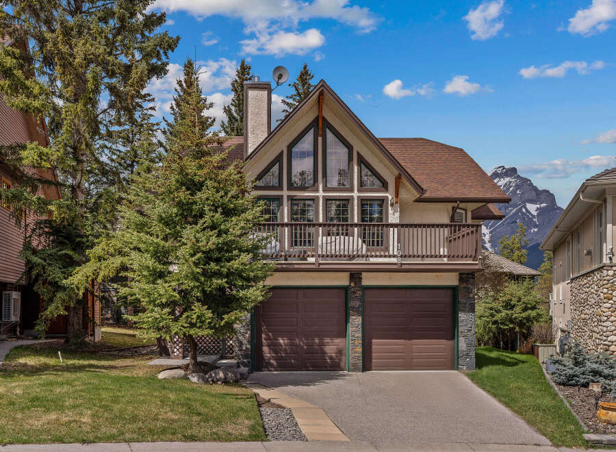 This stunning property boasts a unique architectural design with a charming balcony and a spacious two-car garage.