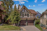 This stunning property boasts a unique architectural design with a charming balcony and a spacious two-car garage.