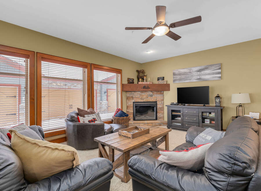Step into a cozy living space with a rustic fireplace, perfect for those chilly evenings.