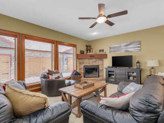 Step into a cozy living space with a rustic fireplace, perfect for those chilly evenings.