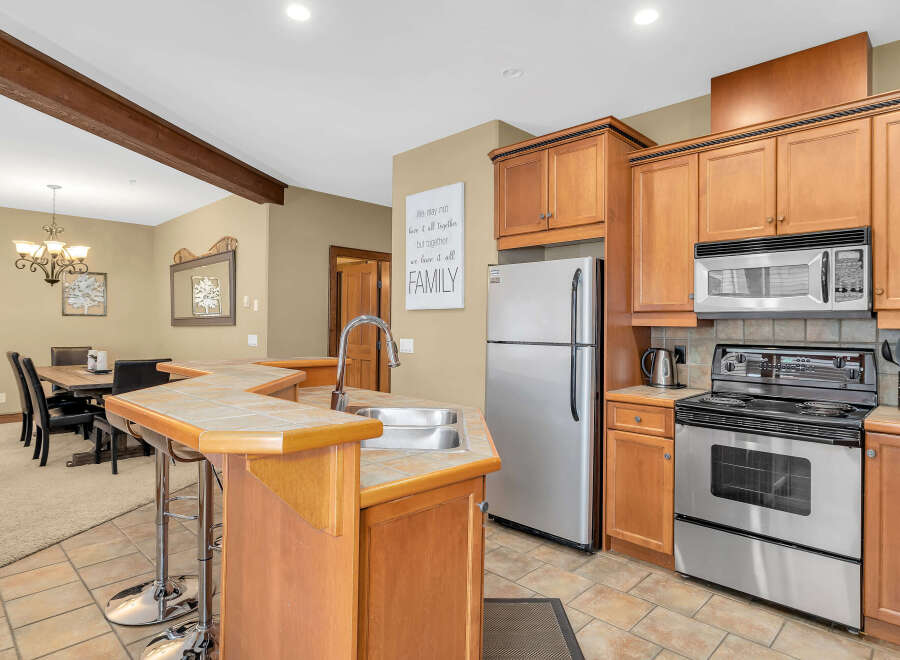 Step into the heart of the home with this stunning kitchen! Featuring beautiful wooden cabinetry, stainless steel appliances, and a convenient breakfast bar, this space is perfect for both everyday living and entertaining.