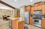 Step into the heart of the home with this stunning kitchen! Featuring beautiful wooden cabinetry, stainless steel appliances, and a convenient breakfast bar, this space is perfect for both everyday living and entertaining.