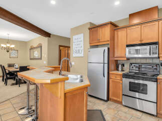 Step into the heart of the home with this stunning kitchen! Featuring beautiful wooden cabinetry, stainless steel appliances, and a convenient breakfast bar, this space is perfect for both everyday living and entertaining.
