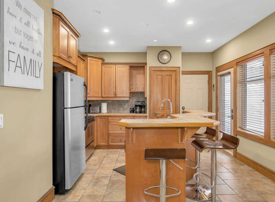 This stunning kitchen boasts beautiful wooden cabinetry, offering ample storage and a warm, inviting atmosphere.