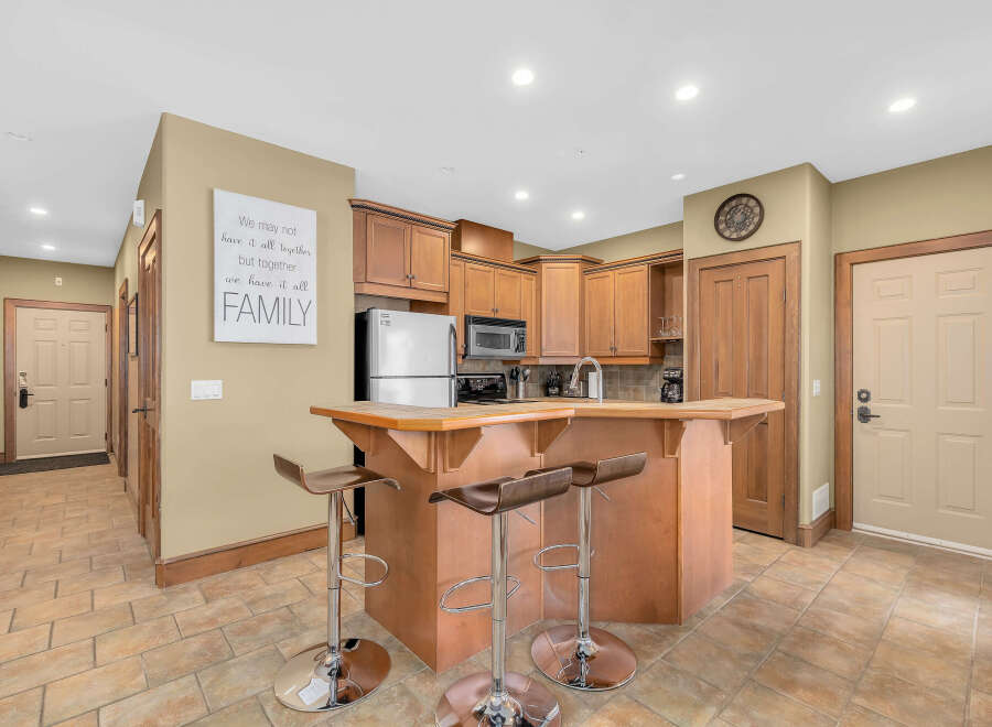 Step into this inviting kitchen, featuring a stylish breakfast bar perfect for casual dining and entertaining.
