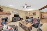 This cozy living room features a stone fireplace, perfect for those chilly evenings.