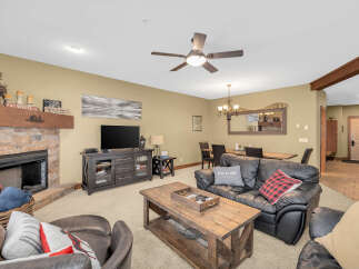 This cozy living room features a stone fireplace, perfect for those chilly evenings.