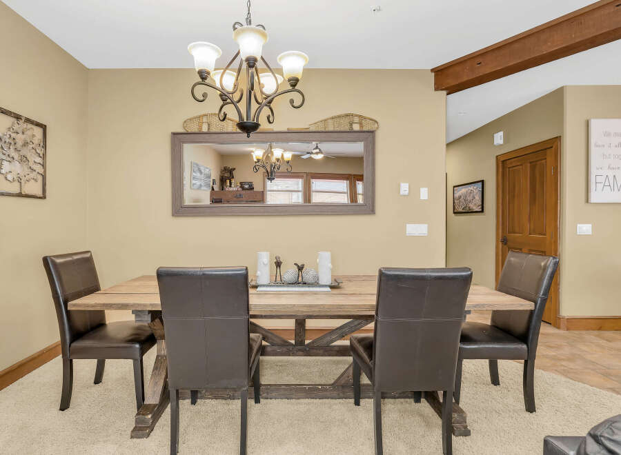 This dining room features a rustic wooden table and comfortable leather chairs, perfect for family gatherings.