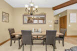 This dining room features a rustic wooden table and comfortable leather chairs, perfect for family gatherings.