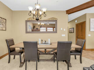 This dining room features a rustic wooden table and comfortable leather chairs, perfect for family gatherings.