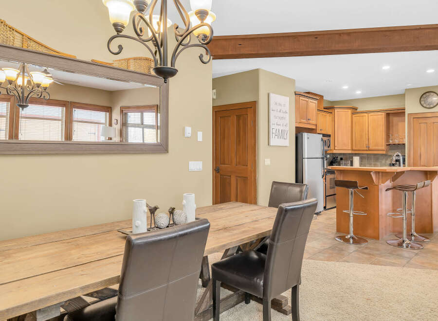 This stunning dining area boasts a rustic wooden table and elegant leather chairs, perfect for hosting gatherings.