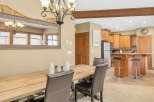 This stunning dining area boasts a rustic wooden table and elegant leather chairs, perfect for hosting gatherings.
