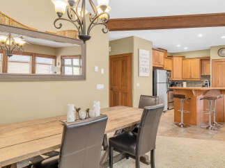 This stunning dining area boasts a rustic wooden table and elegant leather chairs, perfect for hosting gatherings.
