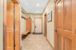 Step into this inviting entryway, showcasing beautiful wood doors and a warm, neutral color palette.