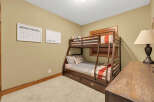 This cozy bedroom features a stylish bunk bed, perfect for accommodating guests or creating a fun space for kids.
