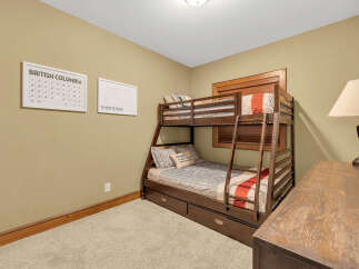 This cozy bedroom features a stylish bunk bed, perfect for accommodating guests or creating a fun space for kids.