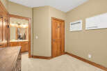 Step into this inviting space, featuring a well-lit hallway with a warm, neutral color palette.