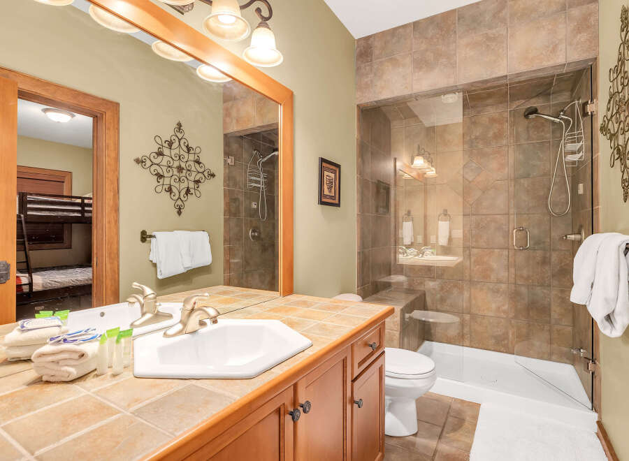 This stunning bathroom features a luxurious walk-in shower with glass doors and elegant tile work.