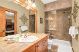 This stunning bathroom features a luxurious walk-in shower with glass doors and elegant tile work.