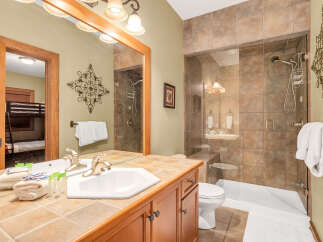 This stunning bathroom features a luxurious walk-in shower with glass doors and elegant tile work.