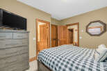 This cozy bedroom features a comfortable bed with a stylish checkered pattern, perfect for a relaxing retreat.