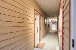 Explore this inviting apartment complex hallway, featuring a warm and welcoming atmosphere.