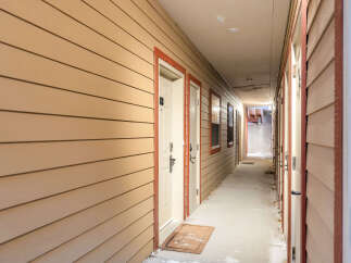 Explore this inviting apartment complex hallway, featuring a warm and welcoming atmosphere.