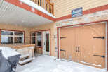 This charming property features a cozy entrance with a covered porch, perfect for enjoying snowy days.