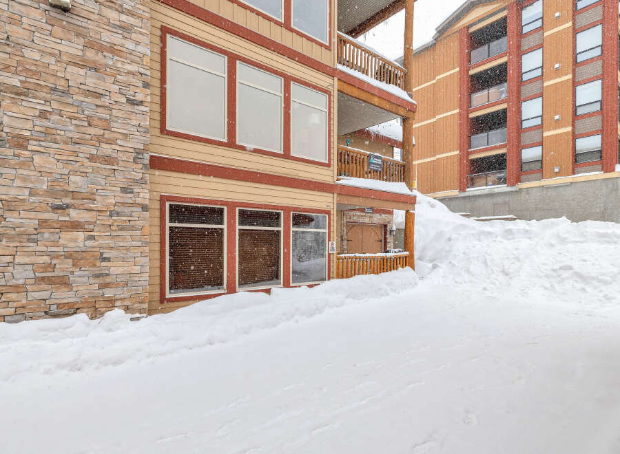 This stunning property boasts a beautiful exterior with stone accents and a warm color palette, creating a welcoming atmosphere.