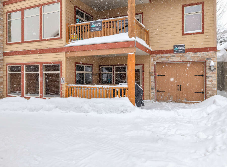 This charming property, nestled in a snowy landscape, offers a cozy retreat.