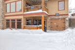 This charming property, nestled in a snowy landscape, offers a cozy retreat.