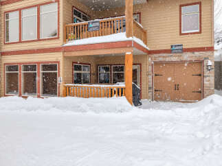 This charming property, nestled in a snowy landscape, offers a cozy retreat.