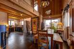 This stunning chalet-style home boasts a warm and inviting interior with exposed wooden beams and a cozy atmosphere.