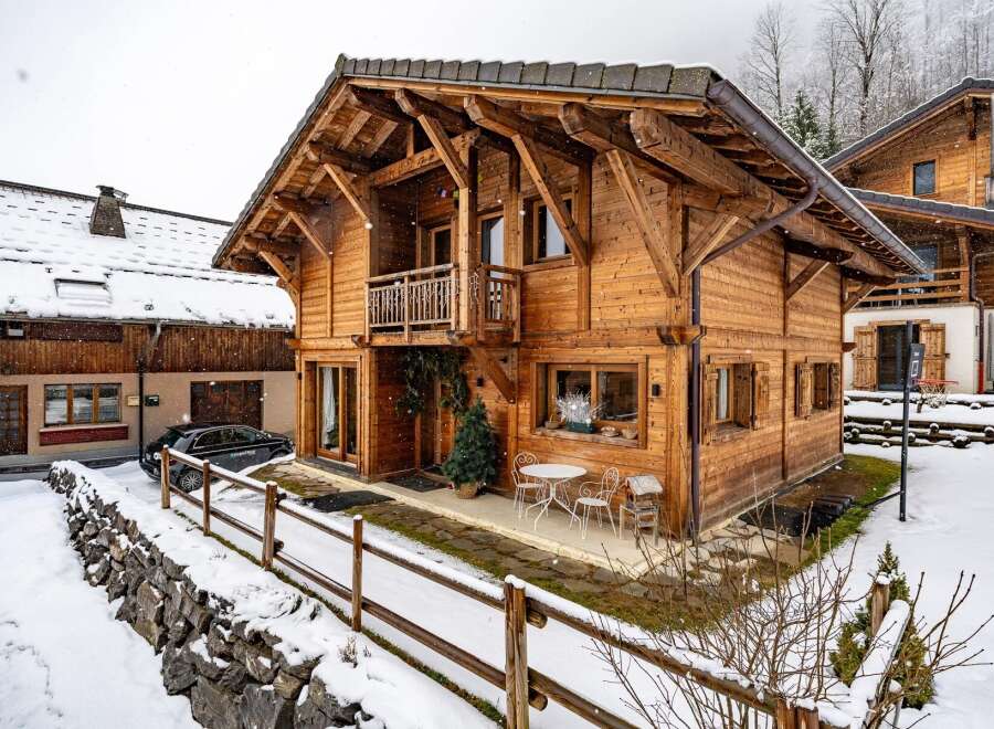 This stunning wooden chalet offers a cozy retreat in a snowy landscape.