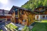 Experience the charm of this stunning wooden chalet nestled in a picturesque mountain setting.