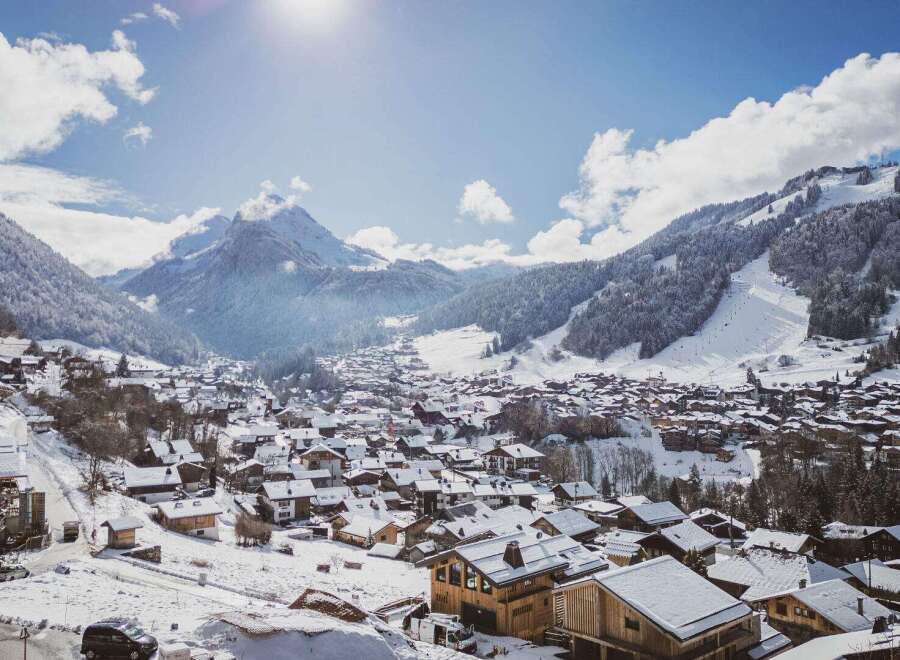 Nestled in a picturesque winter wonderland, this charming property offers stunning views of snow-capped mountains and a quaint village.