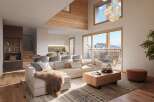 Experience luxury living in this stunning property, featuring a spacious open-plan design with a cozy living area.