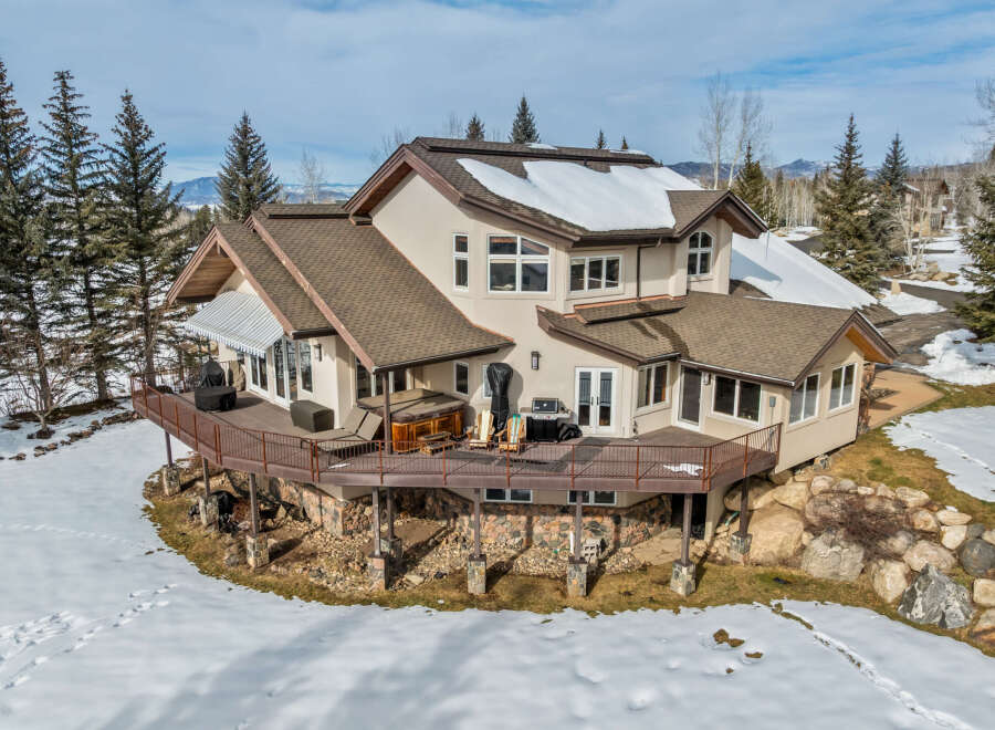 This stunning property boasts a multi-level deck, perfect for enjoying the mountain views.