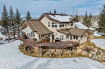 This stunning property boasts a multi-level deck, perfect for enjoying the mountain views.