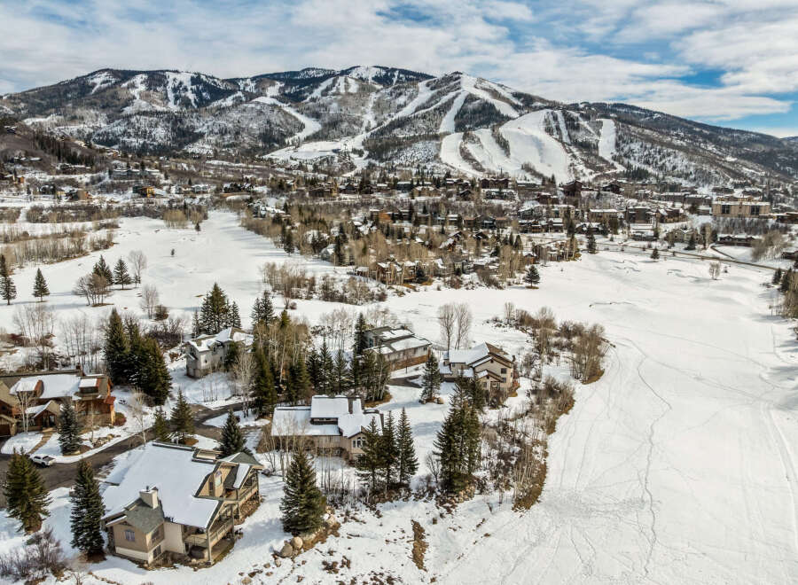 Nestled in a picturesque winter wonderland, this stunning property offers breathtaking views of snow-capped mountains and a pristine, snow-covered landscape.