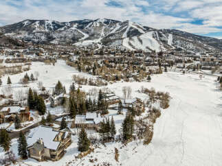 Nestled in a picturesque winter wonderland, this stunning property offers breathtaking views of snow-capped mountains and a pristine, snow-covered landscape.