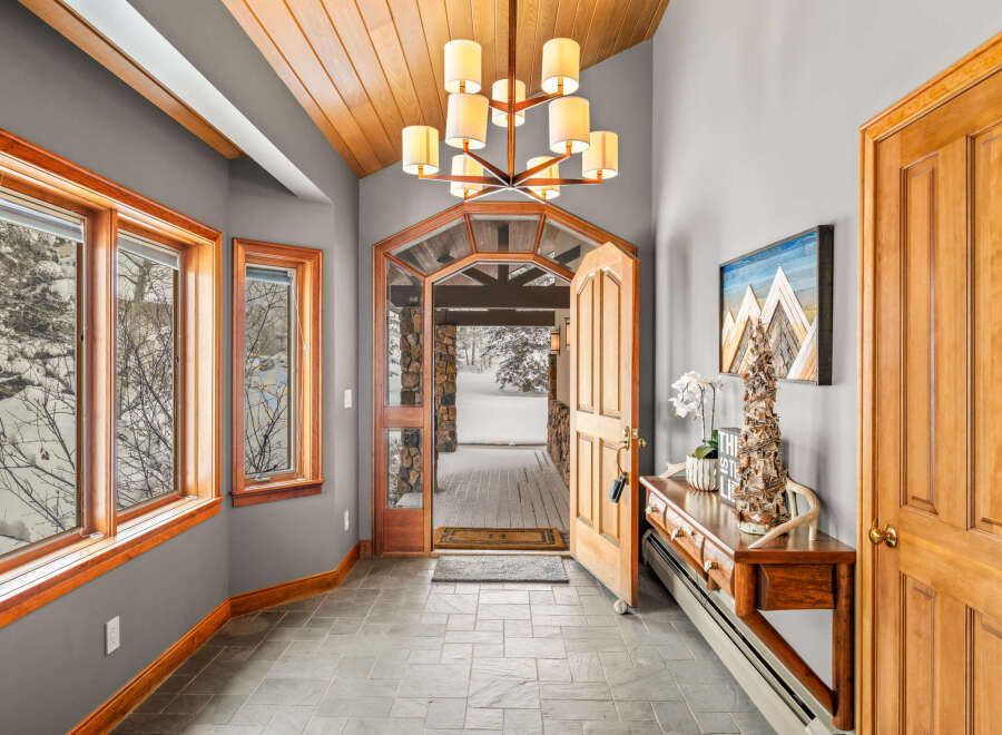 Step into this inviting entryway, showcasing a blend of rustic charm and modern elegance.